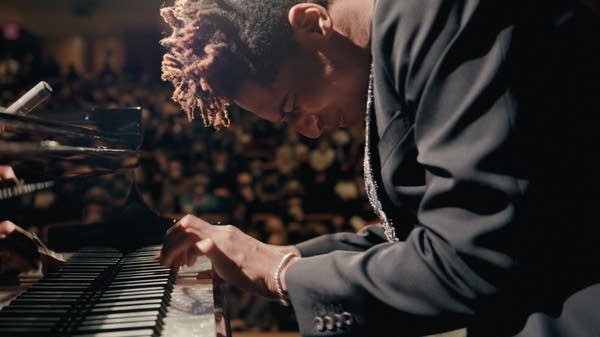 Poster Jon Batiste plays piano