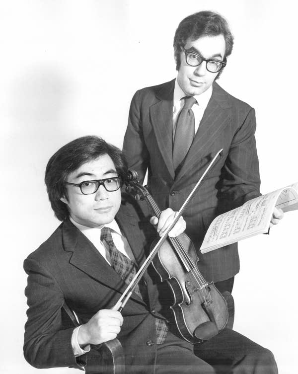 Two musicians pose for a portrait together
